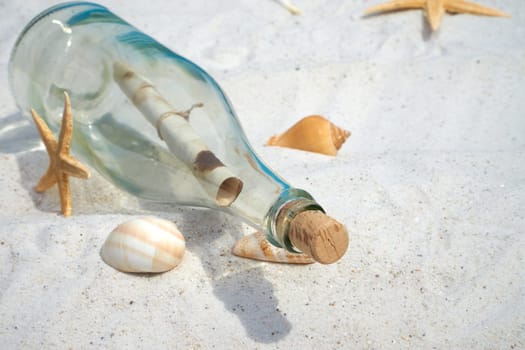 Bottle mail and mussels lie on the sandy beach