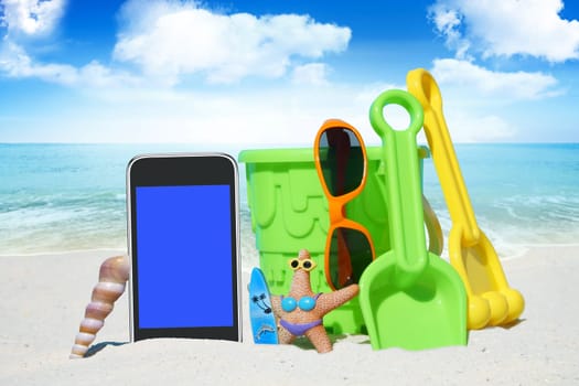 Smartphone,sunglasses and spiezeug on the beach