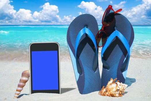 Smartphone,flip flops and sunglasses on the beach