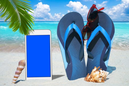 Smartphone,flip flops and sunglasses on the beach