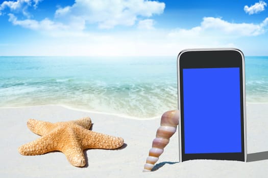 Black smartphone and mussels on the sandy beach