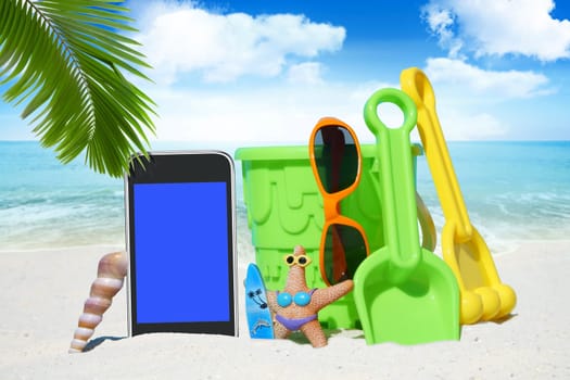Smartphone,sunglasses and spiezeug on the beach