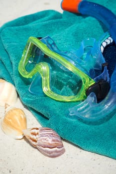 Snorkel and diving goggles on bath towel
