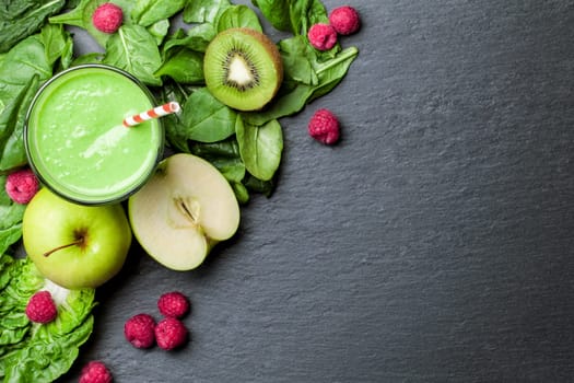 Smoothie green with fruit and vegetables on a chalkboard background