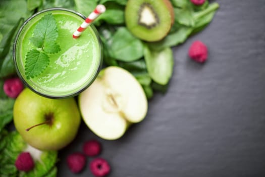 Smoothie green with fruit and vegetables on a chalkboard background