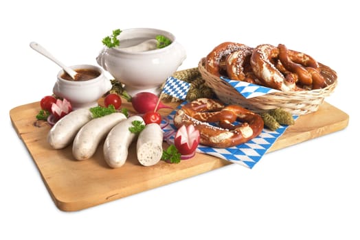 White sausage breakfast with sausages,pretzels and sweet mustard on wooden board