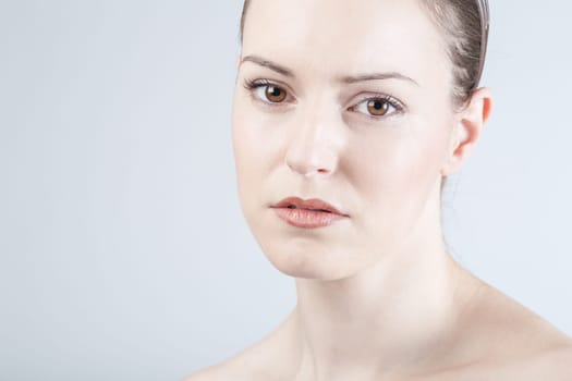 a young woman looks sadly and thoughtfully into the camera