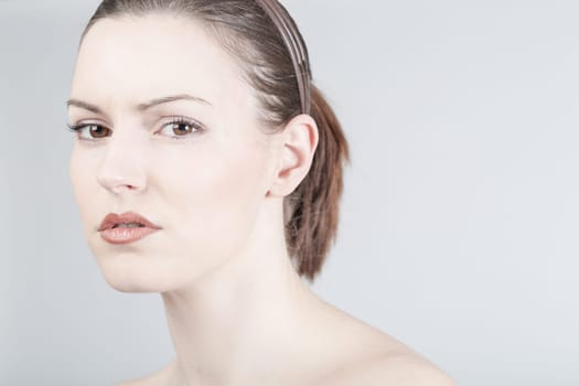 a young woman looks sadly and thoughtfully into the camera