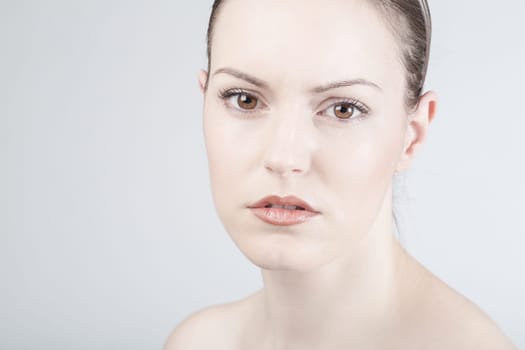 a young woman looks sadly and thoughtfully into the camera
