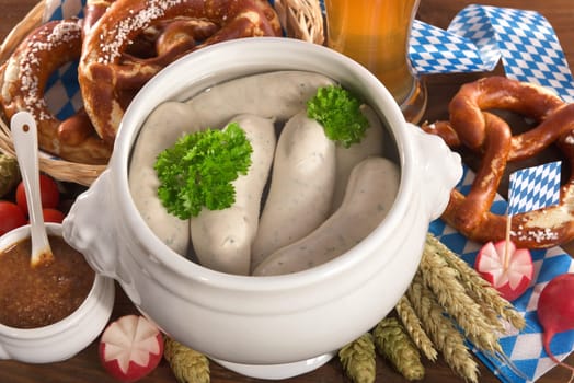 White sausage breakfast with sausages,pretzels,white beer and sweet mustard on wood substrate