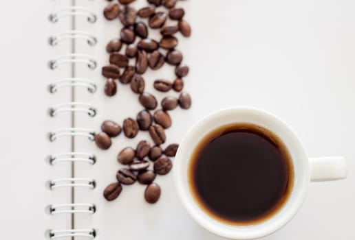 Top view of cup of fresh espresso on notebook, stock photo