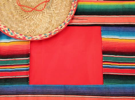 Traditional Mexican fiesta poncho rug in bright colors with sombrero background with copy space
