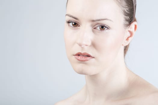 a young woman looks sadly and thoughtfully into the camera