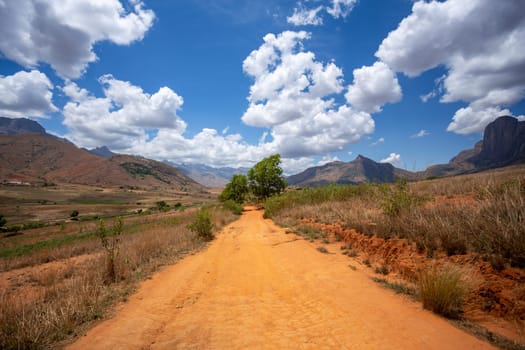 Andringitra national park in Haute Matsiatra region of Madagascar, beautiful mountain landscape sunny day with blue sky. Rural dirty road to valley. Madagascar wilderness landscape.