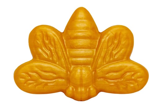 Closeup of a gold yellow natural baby bath soap in the shape of a bee. Clipping path.