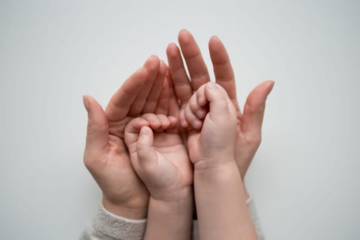 Caucasian adult and child hands together bonding moment in harmony.