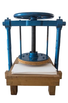 Screw bookbinding press over wooden stand. Isolated over white background
