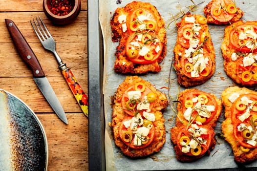 Chicken chops with tomato, olives and cheese. Rustic style