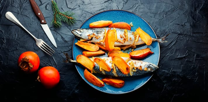 Fish cooked in persimmon fruit marinade on a concrete kitchen table. Whole baked fish, mackerel. Top view.