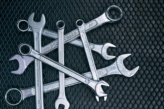 Set of chrome wrenches on steel surface. Mechanic tools for maintenance. Hardware tools to fix. Technical tools background