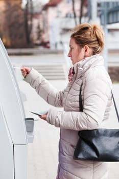 Woman drawing out money from ATM