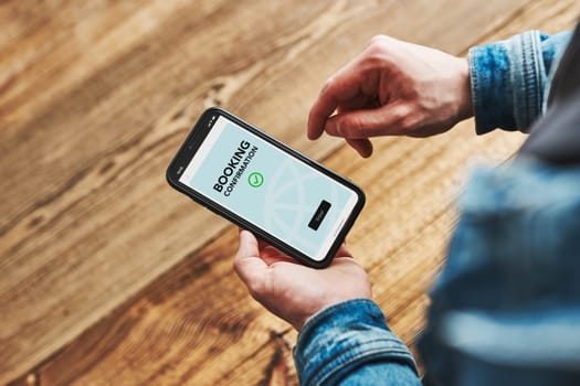 Online booking. Buying tickets and service online. Ordering service in online shop using smartphone. Order confirmation on screen. Person paying online using booking application on mobile phone
