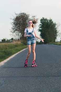 Young girl riding on roller skates. Real people, authentic situations