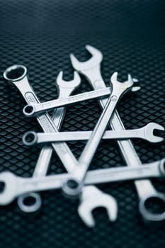 Set of chrome wrenches on steel surface. Mechanic tools for maintenance. Hardware tools to fix. Technical tools background
