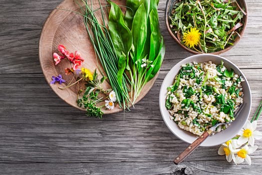 Fresh risotto with spring plants and herbs. Healthy spring food concept
