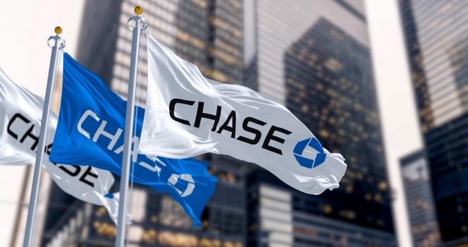 New York, US, March 2023: Flags of Chase Bank waving in the wind in a financial district. JPMorgan Chase Bank is an American national bank. Illustrative editorial 3d illustration render
