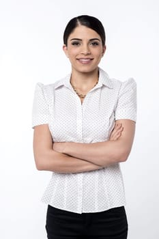Smiling young woman posing with folded arms
