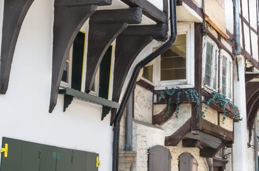Old half-timbered wall of a historic half-timbered house in a city in Germany.