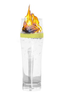 Mineral water glass insulated with burning lemon slice.