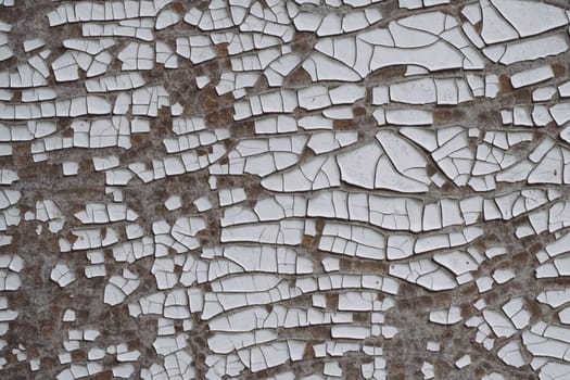 Background texture. Gray surface with white old cracked paint. Top view. Copy space