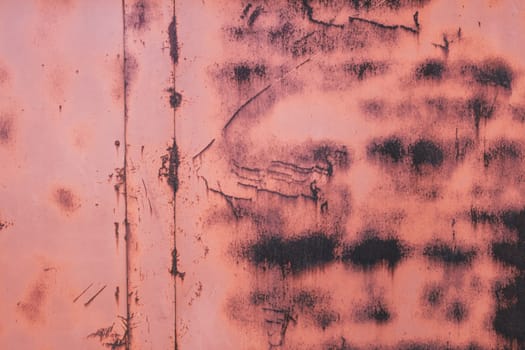 Background texture. Aged metal rusty surface with peeling, faded red orange paint, copy space