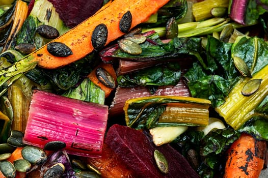 Salad of stewed chard, beetroot and carrots with pumpkin seeds. Vegetarian healthy food concept