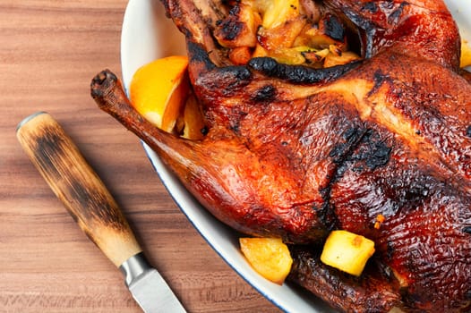 Tasty duck baked with oranges and caramelized apples. Christmas roast goose