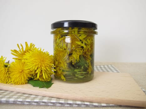 Decoction from dandelion flowers in a glass jar