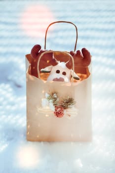 Reindeer toy in a paper bag for Christmas gift
