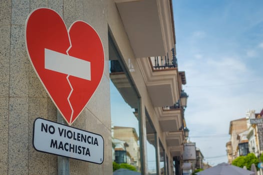 Ronda, Spain, April 2022: No violencia machista traffic sign seen in a shopping street in Spain against transgressive behaviour