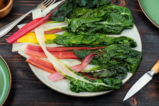 Tasty stewed colorful chard on a plate. Sauteed swiss chard