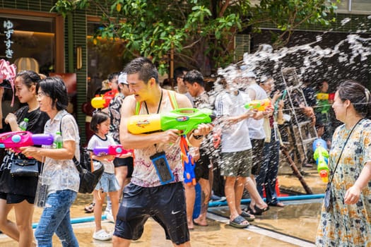 Siam Square, Bangkok, Thailand - APR 13, 2023 Songkran Festival, The short action of people joins celebrations of the Thai New Year or Songkran in Siam Square Bangkok, Thailand.