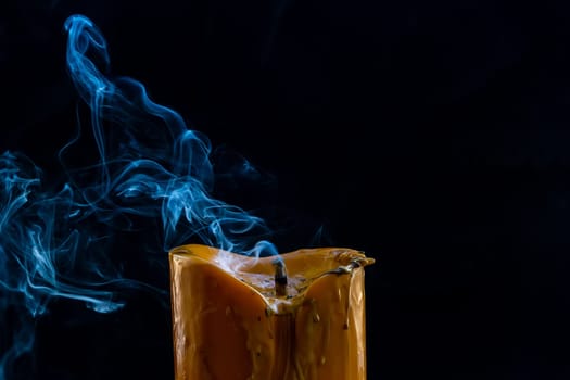 The big candle smoke is colorful. It is abstract.
