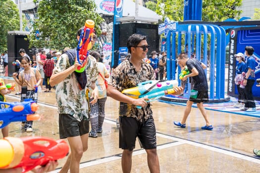 Siam Square, Bangkok, Thailand - APR 13, 2023 Songkran Festival, The short action of people joins celebrations of the Thai New Year or Songkran in Siam Square Bangkok, Thailand.