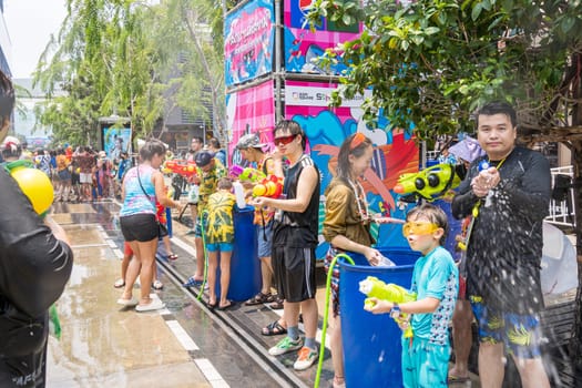 Siam Square, Bangkok, Thailand - APR 13, 2023 Songkran Festival, The short action of people joins celebrations of the Thai New Year or Songkran in Siam Square Bangkok, Thailand.
