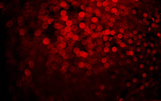 Abstract blur red glitter on black background. Card for Valentine's day, christmas and wedding celebration. Love bokeh sparkle confetti textured layout. Classy elegant design.