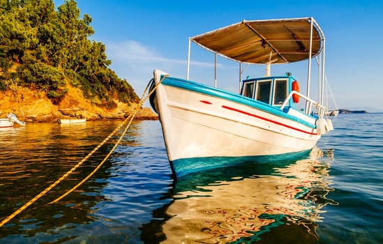 Traditional colorful boats in old town of Skiathos island, Sporades, Greece. Scenic view of aegean sea. Popular summer holiday destination scene.