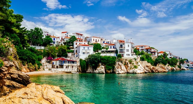 Old town view of Skiathos island, Sporades, Greece. Greek traditional architecture and aegean sea. Popular summer holiday destination scene.