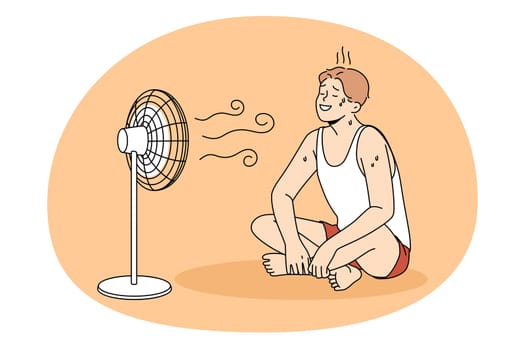 Sweating and cooling air concept. Young positive man in sportswear sitting on floor sweating and enjoying work on air fan wind vector illustration