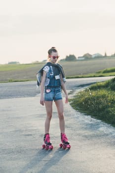 Young girl riding on roller skates. Real people, authentic situations